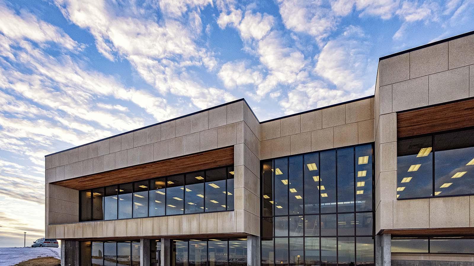 West side of Welder Library with large sky and clouds in the background.